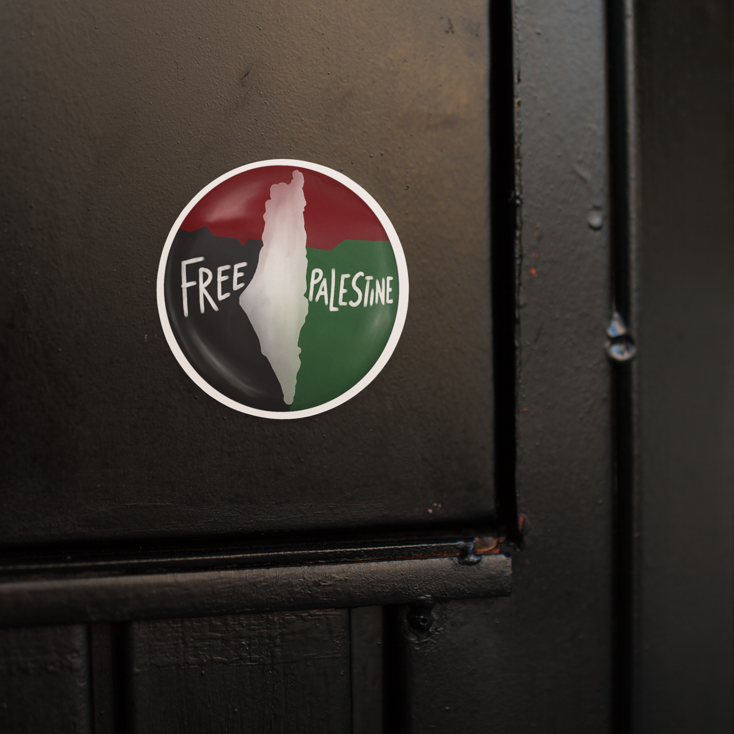 Sticker with 'Free Palestine' text on a black surface