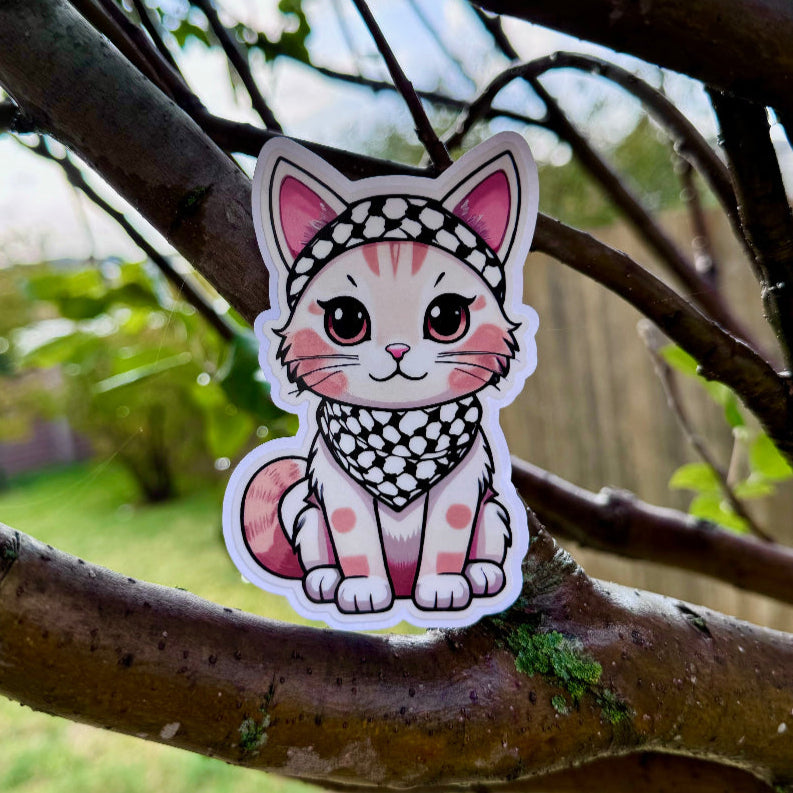 Palestinian cat sticker with a Keffiyeh on a tree branch