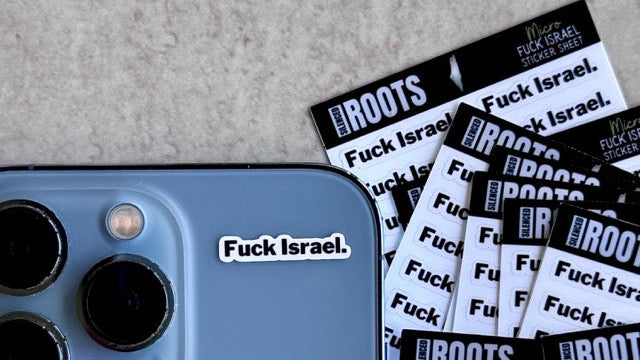 Phone with 'Fuck Israel' sticker and multiple sheets of stickers on a textured surface
