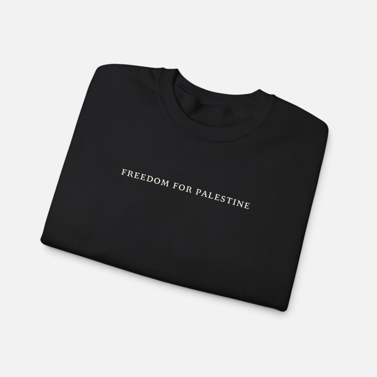 Silenced Roots black crewneck sweatshirt with white Freedom for Palestine text printed on the chest.