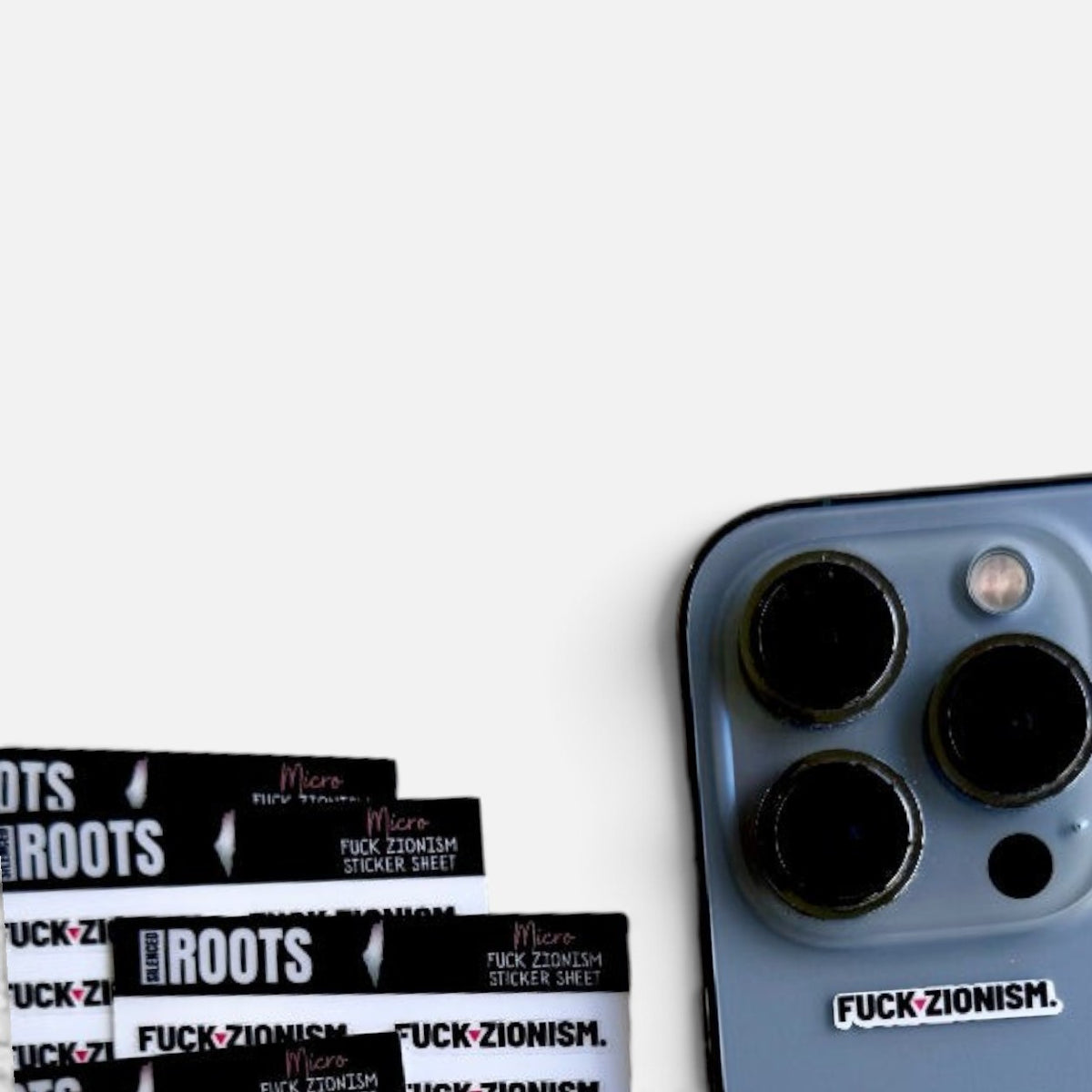 Silenced Roots sticker sheet with black and white micro protest decals applied to a smartphone camera housing