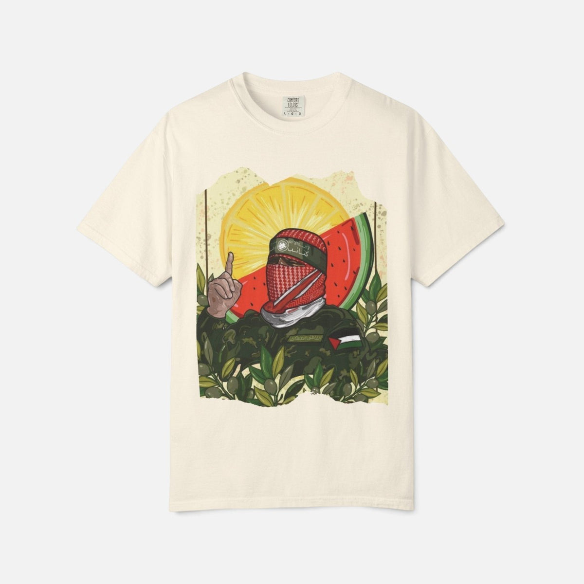 Silenced Roots Comfort Colors cream cotton tee featuring Palestinian resistance artwork with a keffiyeh-clad figure.